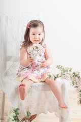 little girl with flowers indoor