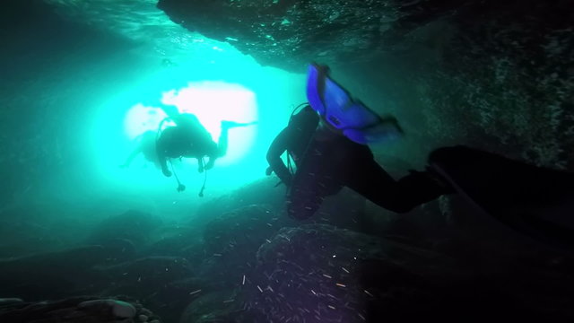 Scuba Divers In An Underwater Cave.
