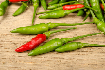 Green and red Thai chili peppers