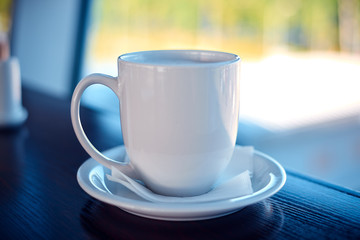 White coffee cup on a airport window background