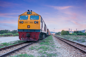 Fototapeta na wymiar Cargo train and container at twilight