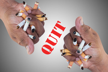 Hand Man Crushing Cigarettes Concept No Smoking on gray background