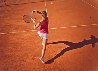 Young woman playing tennis.High angle view.Forehand.