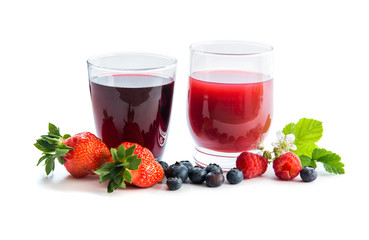 Glasses of fresh blueberry and strawberry juice with berries 