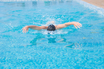 Young girl swimming butterfly stroke style