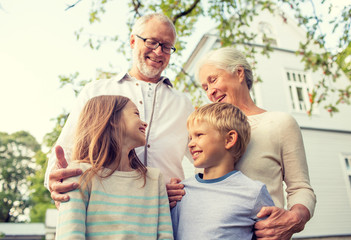 happy family in front of house outdoors