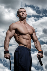 Muscular man under cloudy sky