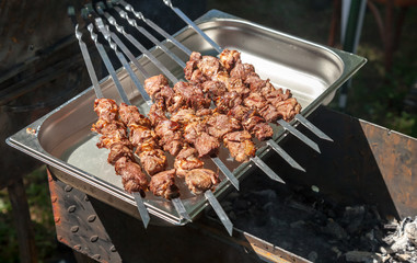 Appetizing hot shish kebab on metal skewers