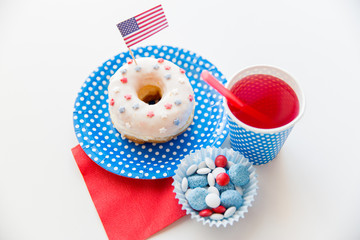 Fototapeta na wymiar donut with juice and candies on independence day