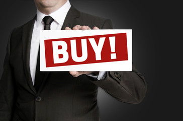 Buy sign is held by businessman