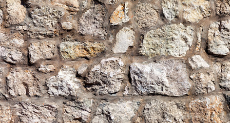 Fragment of a grey stone wall as background