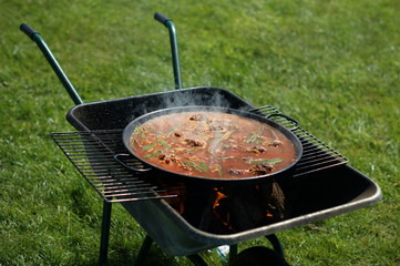 Paella being cooked on a barbecue