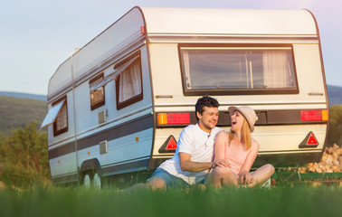 Young couple with a camper van