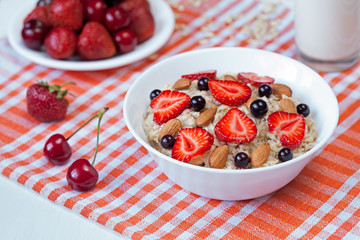 Oatmeal porridge helathy breakfast with strawberry, cherries