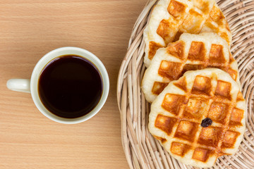 Morning breakfast with black coffee and raisin waffle