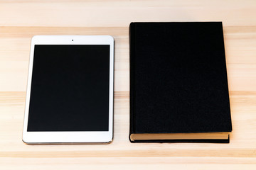 Fototapeta premium book and tablet on the table