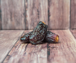Date fruits over wooden background