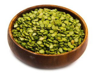 dried peas on wood bowl isolated on white