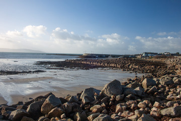 A view of Barna beach Co. Galway, Ireland, with Barna pier in the distance
