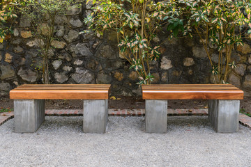 Wooden bench in public park open space.