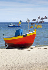 Naklejka na ściany i meble Fishing boat on the beach. Landscape with Baltic Sea.
