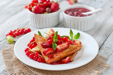 French toast with berries and jam for breakfast
