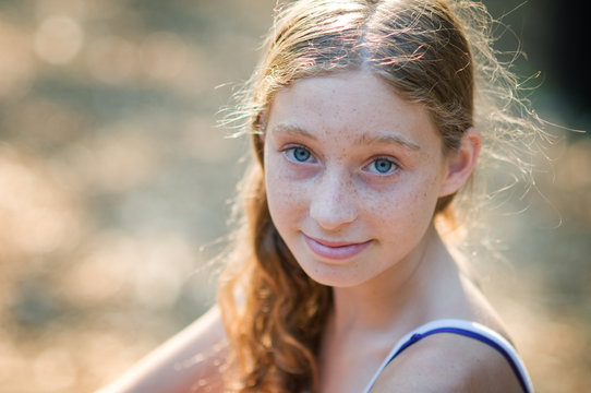 Closeup Of A Pretty Teenaged Girl With Blue Eyes And Freckles