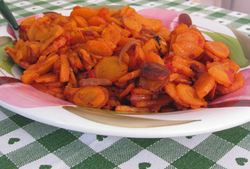Plate of stir-fried carrots. The ingredients are chopped carrots, tomato sauce, garlic, sage, olive oil
