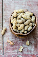 Peanuts in shell pod in bowl