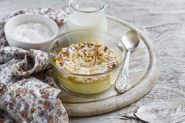 cottage cheese casserole in glass bowls on a light wooden background