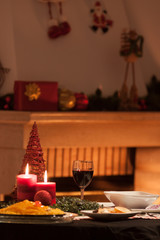Christmas Table with candles and glass of red wine