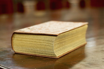 Ancient book above a wood table