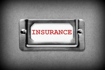 Insurance index card in a storage cabinet drawer handle