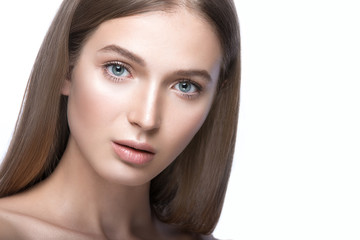 Fototapeta premium Beautiful girl with a light Nude make-up and blond hair. Beauty face. Picture taken in the studio on a white background.