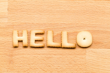 Word hello cookie over the wooden background