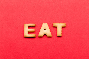 Word eat cookie over the red background