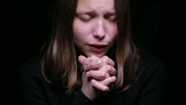 Praying teen girl