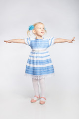 Little girl standing with outstretched arms