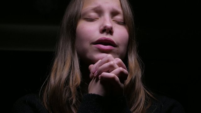 Praying teen girl