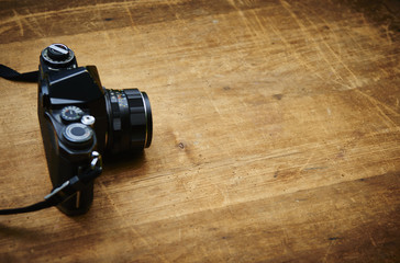 Vintage photo camera on a wooden table