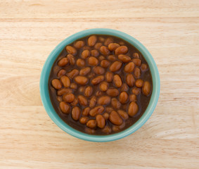 Country style baked beans in a bowl on table