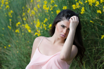 Naklejka na ściany i meble Cute Greek girl standing front of yellow bush