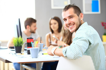 Image of smart young businessmen looking at camera at meeting