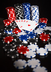 Poker chips and cards isolated on black background