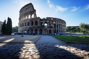 Naklejka na ściany i meble Colosseum in Rome and morning sun, Italy