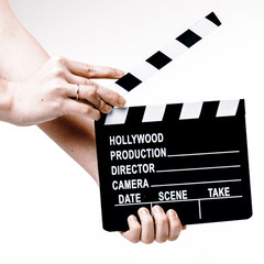 Movie flapper in woman´s hands on white background