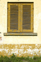 Old wooden orange shutters on window , Bulgaria