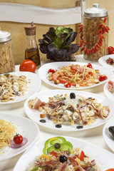 Several kinds of prepared pasta served on the table.