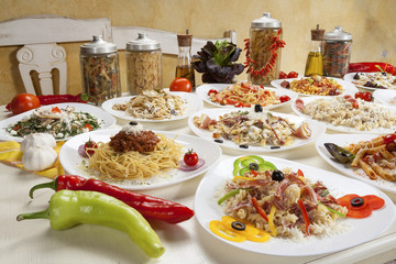 Variety of raw and prepared pasta served on the table.
