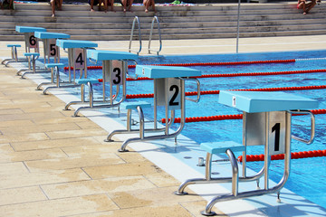 View of a row of diving boards in a Olympic pool.